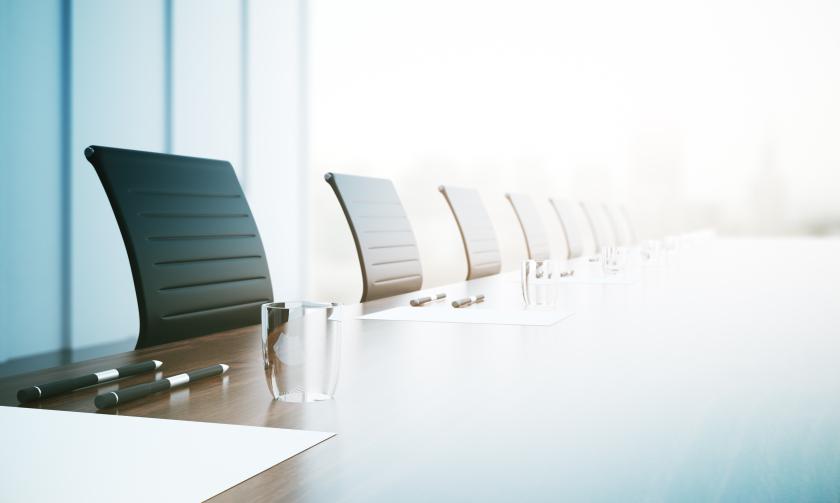 chairs lined up around a large table 
