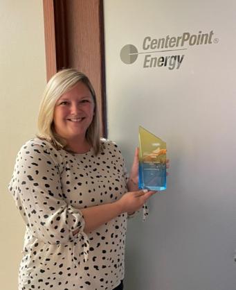 centerpoint staff member holding award