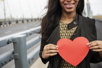 diverse woman holding a heart